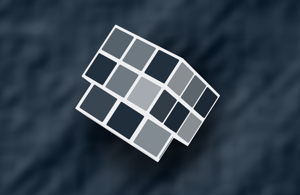 The Puzzle Cube screensaver in the Slate style: a pale cube mid-turn over softly shaded grey-blue terrain.